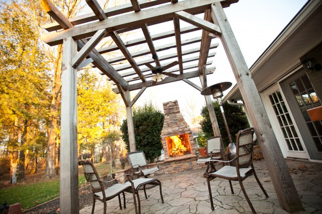 Outdoor fireplace on patio with pergola